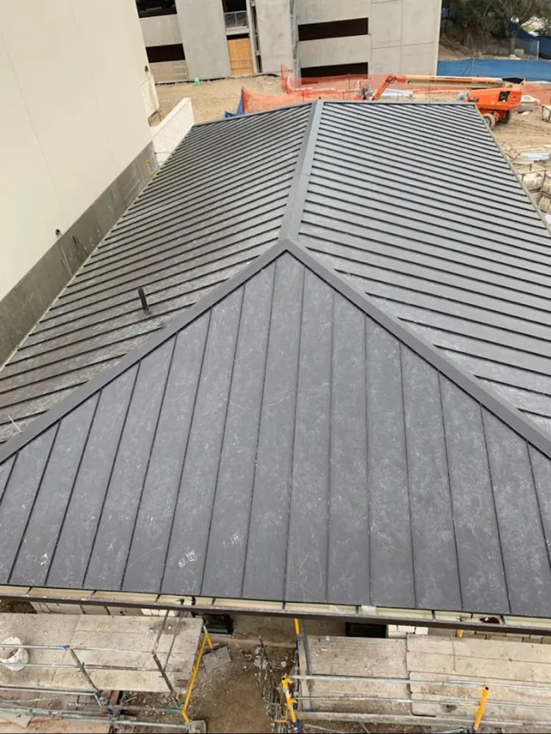 Commercial metal roof construction with crane equipment in Lansdowne